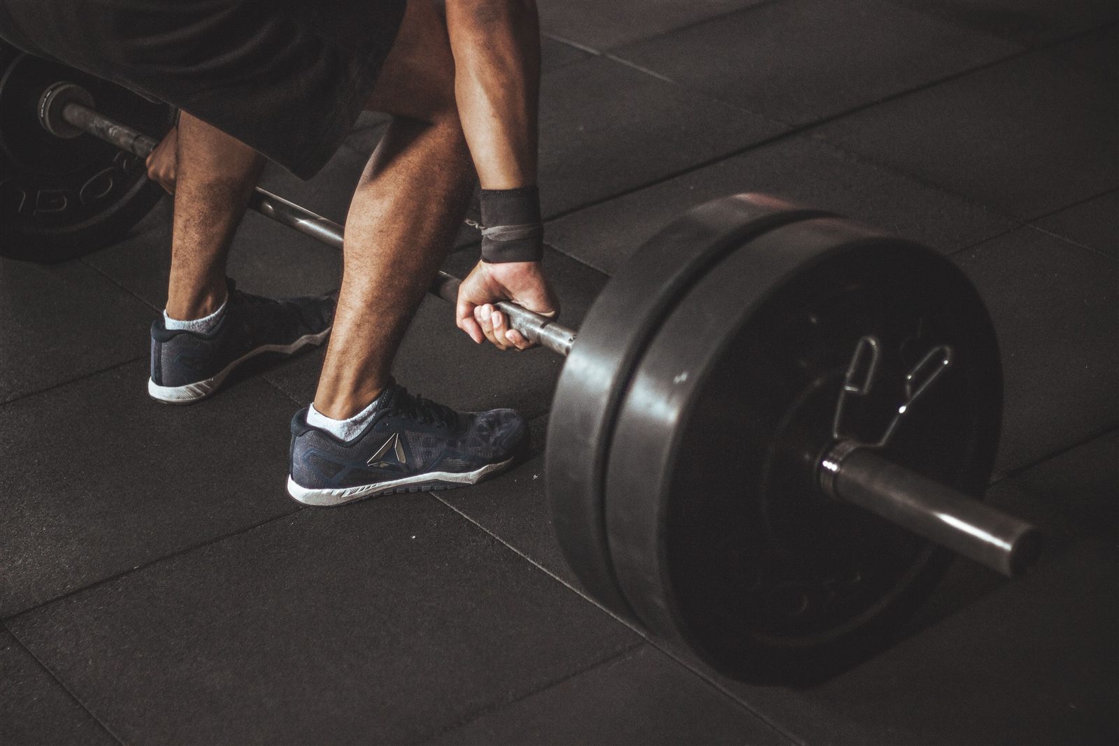 Lifter gripping a loaded barbell