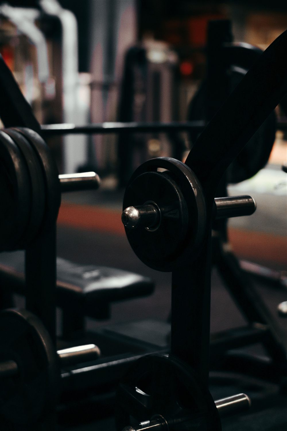 Plate-loaded rack in a dark gym